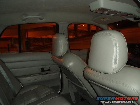 Interior view of a gray leather rear seat and door panel