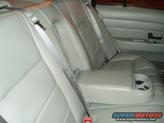 Rear seats and armrest with cup holders in a car
