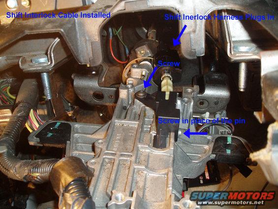 Steering column interior with shift interlock cable and harness
