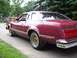 1979 Ford Thunderbird - Rear quarter view of a maroon coupe with a vinyl roof and gold wheels.