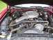 1979 Ford Thunderbird - The engine bay of a red 1979 Ford Thunderbird is shown, revealing the V8 engine and associated components.