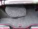 1979 Ford Thunderbird - The interior of a car trunk is shown, covered in grey carpeting.