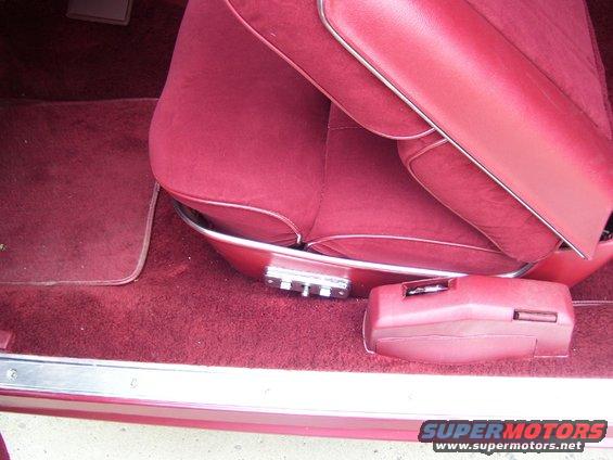 Red interior with plush seats, floor mats, and a center console