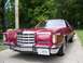1979 Ford Thunderbird - A maroon Ford Thunderbird is parked on a dirt road with trees in the background.