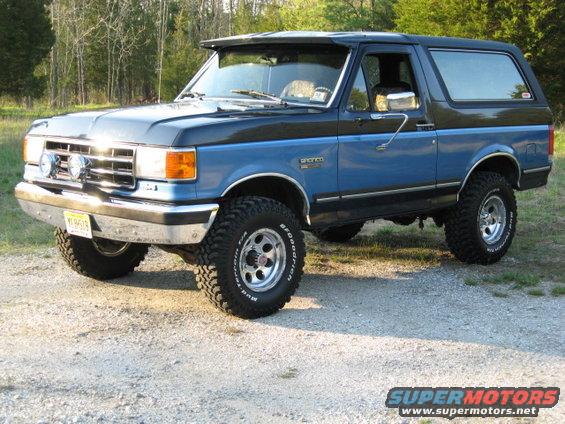 Blue and black 1990 Ford Bronco parked outdoors
