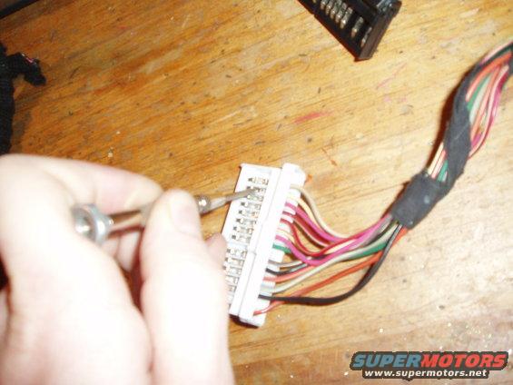 pull out the plastic taps on each side of the harness and use a small screw driver at and angle to free the pins.