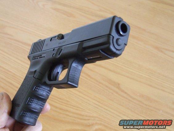 Black semi-automatic pistol held in hand, front view