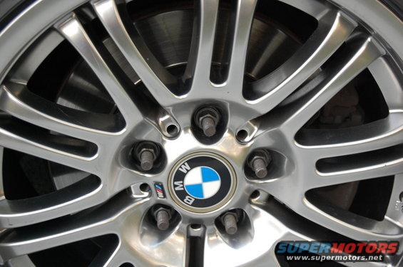 Close-up of a BMW alloy wheel showing the center cap with BMW logo and M badge