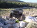 1984 Ford Bronco II - This heavily modified truck navigates a rocky trail with its tires at extreme angles.