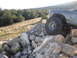 1984 Ford Bronco II - A gray SUV with large tires is shown traversing a rocky, off-road landscape.