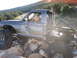 1984 Ford Bronco II - A heavily modified pickup truck navigates a rocky terrain, its off-road capabilities.
