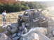 1984 Ford Bronco II - This heavily modified SUV is navigating a challenging rocky obstacle course.
