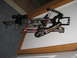 1988 Jeep Comanche - A crossbow with a scope and arrows is mounted on a wall.