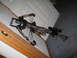 1988 Jeep Comanche - A crossbow with a camouflage pattern and scope is shown resting against a door.