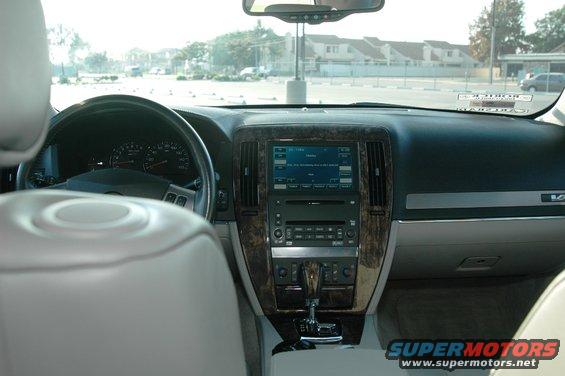 2006 Cadillac STS interior dashboard with navigation screen and wood trim