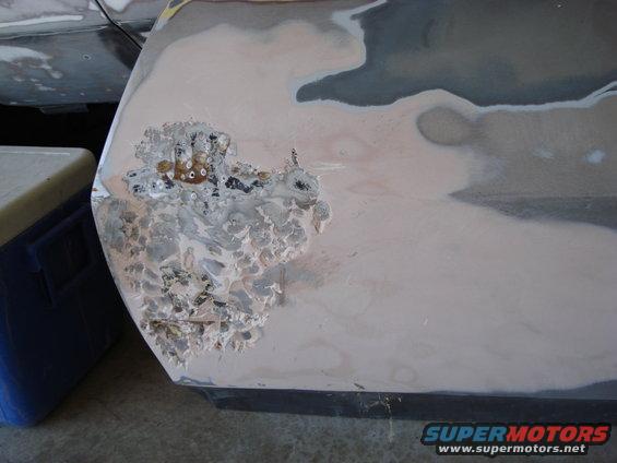 Rusted metal panel with body filler and primer