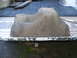 1979 Ford Bronco - This is an oil pan, likely removed from a vehicle, resting on a truck bed liner.