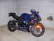 2002 Buell Lightning w/Fairing - A blue Suzuki motorcycle is parked indoors against a tiled wall, showing its front three-quarter view.