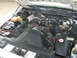 1997 Ford Crown Victoria - The engine bay of a vehicle, the fan shroud with 'CAUTION FAN' text and various engine components.
