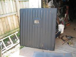Black tailgate with a square cutout and ribbed texture