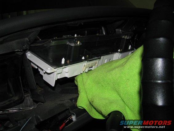 img_6786.jpg Removal of the gauge cluster. Place a towel over the steering column to prevent scratching or marring.  Two harnesses must be diconnected from the gauge cluster. 