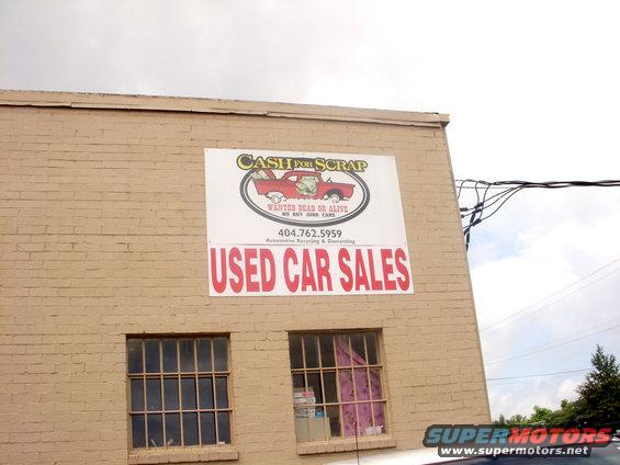 Sign for used car sales and cash for scrap with phone number 404.762.5959