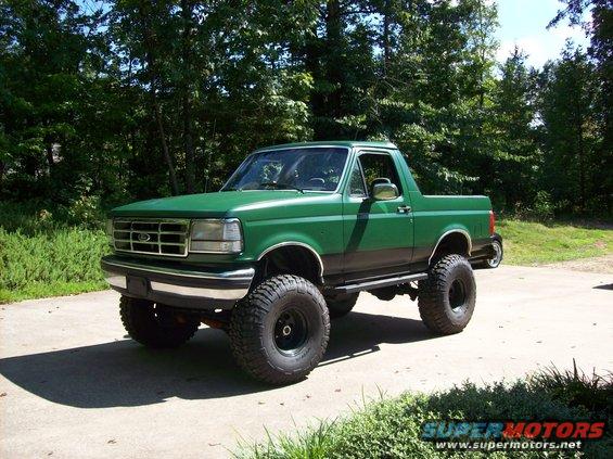 Green lifted 1992 Ford Bronco parked on a driveway