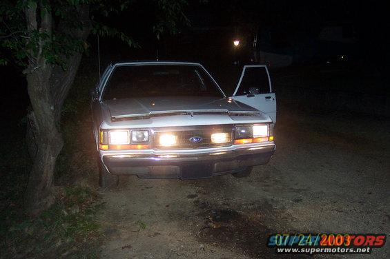 1991 Ford Crown Victoria LTD parked at night with driver's door open