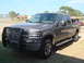 2005 Ford F-250 - This 2005 Ford F-250 truck is seen from a three-quarter front angle, equipped with a brush guard.
