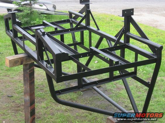 Black metal frame on wooden supports, side view
