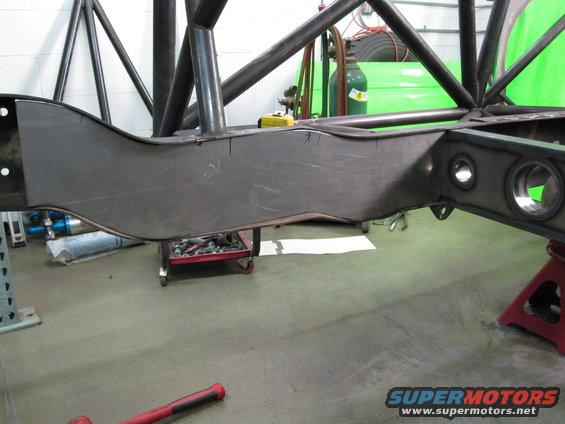 Custom fabricated metal frame section with roll cage tubing, on jack stands