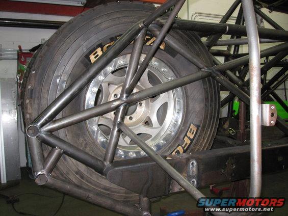 Spare tire mounted within a custom metal roll cage structure