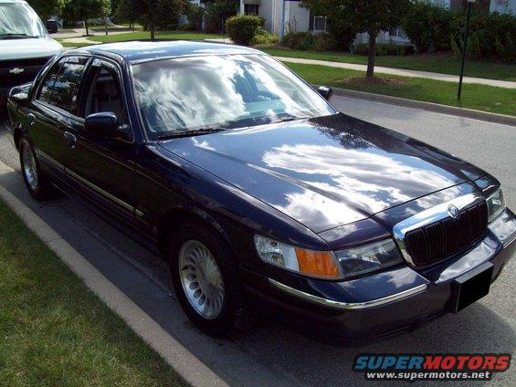 Dark blue 1999 Mercury Grand Marquis parked curbside