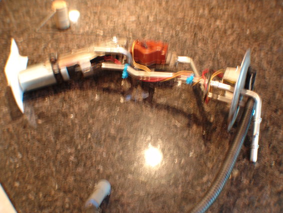 Fuel pump assembly with wiring and hoses on a speckled countertop