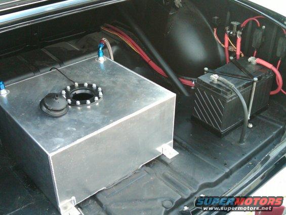 Aluminum fuel tank and battery in a car's trunk