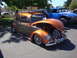 1964 Ford Fairlane - A custom two-tone Volkswagen Beetle is displayed with its hood open, its engine and spare tire.