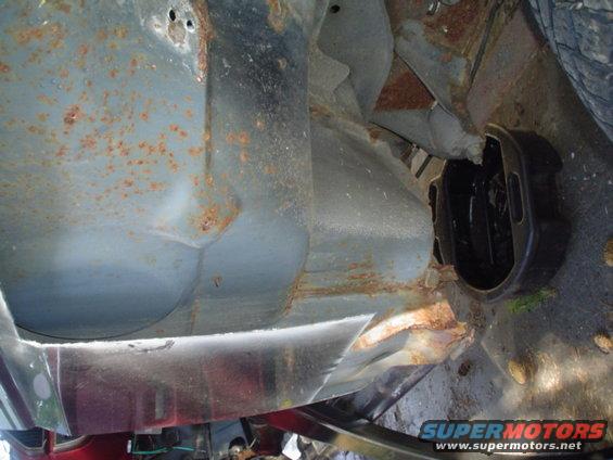 rusted frame and suspension parts of a vehicle, showing significant corrosion