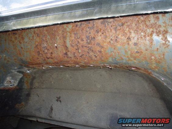 rusted out wheel well area of a vehicle