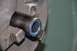 1996 Ford Bronco - Close-up of a metal part with a blue ring, secured in a lathe chuck for machining.
