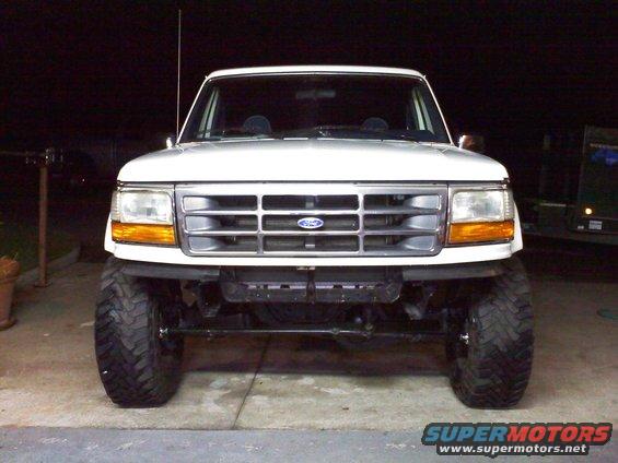 Front view of a white Ford Bronco with aftermarket wheels and tires