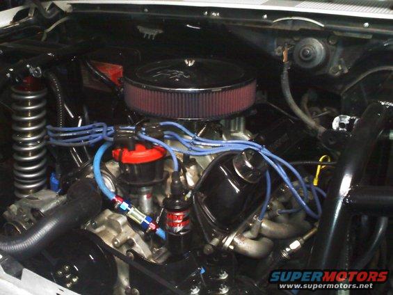 Engine bay with V8 engine, air filter, distributor, and spark plug wires