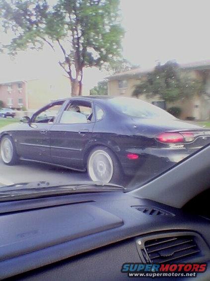 Black 1999 Ford Taurus sedan, side view