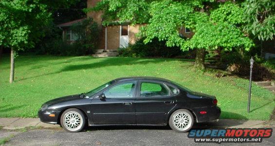 Black 1999 Ford Taurus sedan parked curbside