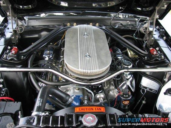 Engine bay with chrome air cleaner and "CAUTION-FAN" sticker