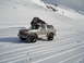 1992 Ford Bronco - Silver 1992 Ford Bronco parked on a snowy track with mountains in the background.