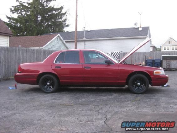 Red 2000 Ford Crown Victoria, side view, hood open