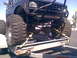 1984 Ford Bronco II - A heavily modified 1984 Ford Bronco II, equipped with oversized tires and a protective front cage, is seen being transported on a trailer.