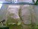 1984 Ford Bronco II - Two car floor mats are visible, one is partially covered by a burlap sack, and the other is laid out on a rug.
