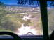 1984 Ford Bronco II - Driving through a dusty trail with a view of a town in the distance.