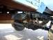 1973 Ford Bronco - Close-up view of the undercarriage and suspension of a weathered vehicle.
